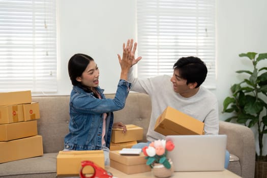 In a lively moment of triumph, this couple celebrates their hard work and collaboration in building their online business, showcasing their dynamic relationship.