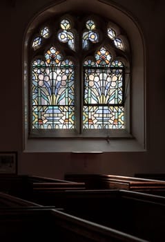 Windsor, UK - Apr 03, 2025 - View of Glass stained windows inside of Parish Church of St John the Baptist. use it as your Wallpaper, Poster and Space for text, Selective focus.