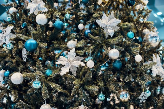 Decorated Christmas tree. Decorated Golden Christmas tree with patchwork ornament artificial stars, white flowers, for New year.