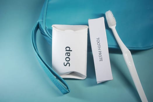 A toiletry kit featuring soap and toothpaste beside a toothbrush.
