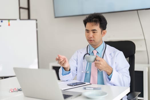 Integrating telemedicine into daily practice, the physician balances patient consultation with a personal touch, showcasing the modern approach to healthcare.