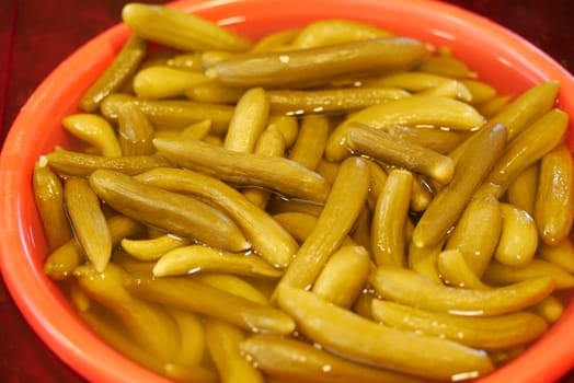 A vibrant bowl filled with pickled vegetables on display at a market.