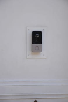 A sleek doorbell installation on a clean, white wall enhances modern decor.