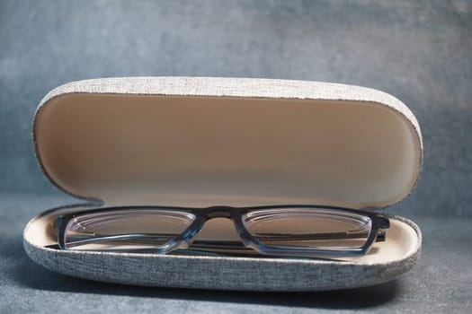 Reading glasses are neatly placed inside a soft case.