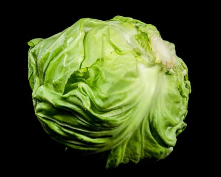 Close-up of a fresh green cabbage with textured leaves, isolated on a black background. Perfect for healthy food and organic farm concepts