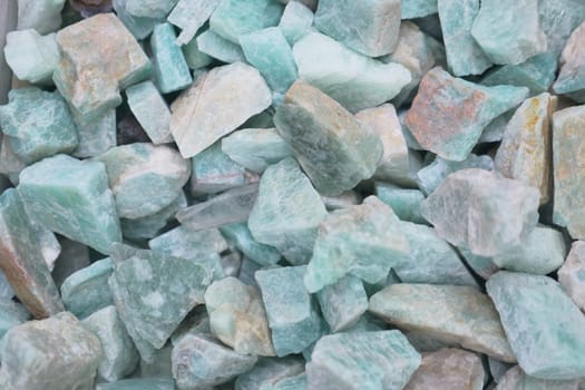 Aquamarine crystals of various sizes are scattered evenly, reflecting light.