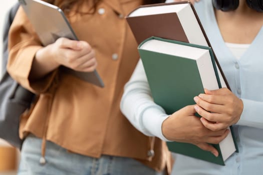 Showing their study essentials, two students pose together with their academic materials, ready to tackle the next challenges in their education.