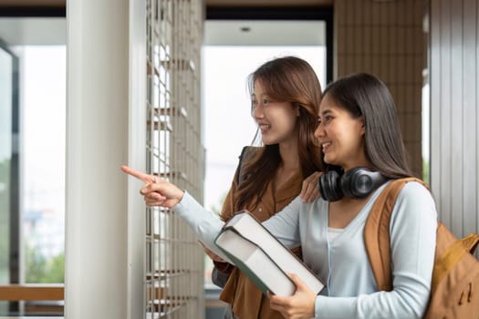 Two friends share a moment of excitement while exploring campus opportunities, reflecting the vibrant university experience.