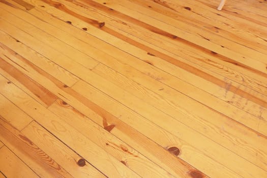 Warm, polished hardwood floor with natural grain and rich tones visible.