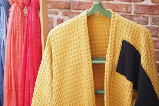 Brightly colored fabrics hang in a cozy crafting studio for creative projects.