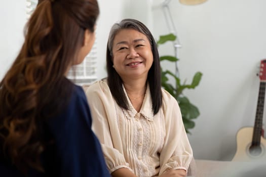 A caregiver shares a friendly moment with an elderly patient, promoting emotional well-being and trust in their home. The setting emphasizes companionship and support.