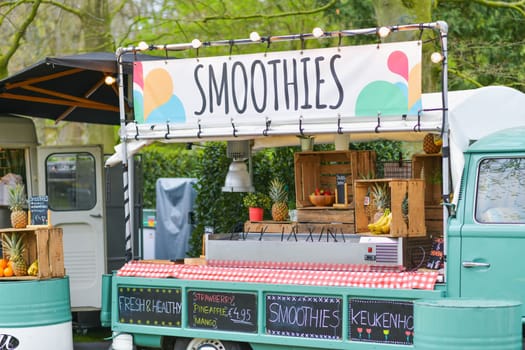 Lisse, Netherlands - April 17, 2019: Mobile bar minivan on wheels for selling snacks and smoothies in a Keukenhof park Decoration