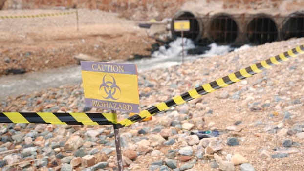 Close up of warning sign lable biohazard caution of collects sample of waste water from industrial, Conserve water and Environment Issue concept