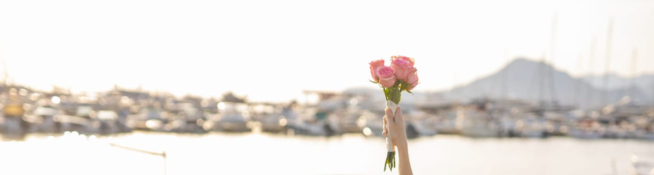 Banner hand holding a beautiful bouquet of roses flowers. Bouquet of flowers for congratulations. Copy space for text. Wedding bouquet.