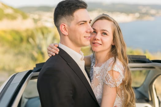 Couple embracing outdoors after wedding ceremony. Love, happiness, partnership and emotional connection in a joyful romantic moment.