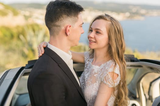 Newlyweds enjoying a quiet moment by the sea. Love, wedding and togetherness in the beginning of a shared journey.