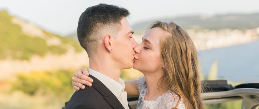 Newlyweds enjoying a quiet moment by the sea. Love, wedding and togetherness in the beginning of a shared journey.