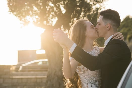 Bride and groom standing in golden sunlight after ceremony. Joy, new beginnings and emotional connection on a wedding day