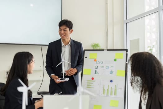 In a collaborative setting, team members examine ESG data, discussing insights and strategies for promoting sustainable growth within the organization.