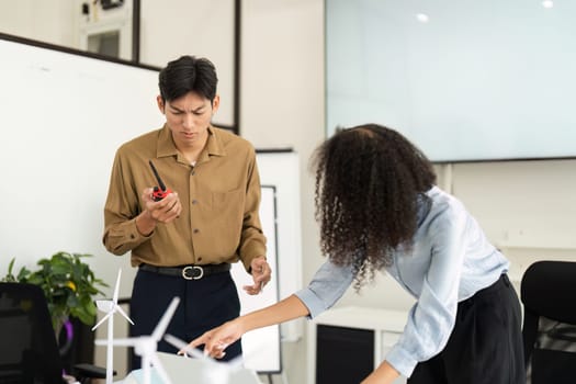 Professionals working in a collaborative environment to tackle renewable energy issues, highlighting the importance of teamwork in sustainability efforts.