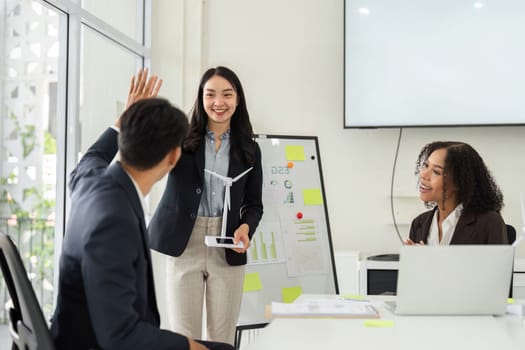 In a collaborative meeting, a team member presents innovative ESG initiatives while actively engaging their colleagues through discussion.