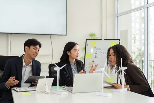 In a collaborative environment, professionals are engaged in a thorough discussion on sustainable practices aimed at improving ESG performance and corporate responsibility.