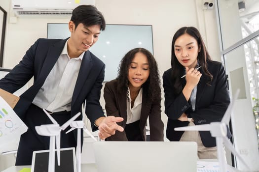In a collaborative setting, a team analyzes data and explores innovative solutions for promoting environmental responsibility in their projects.