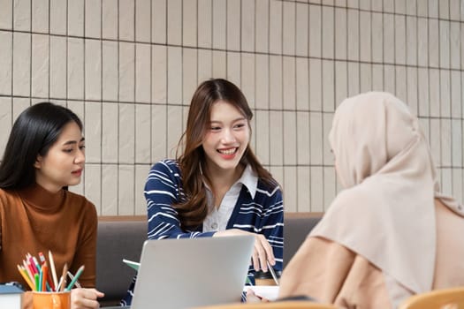 Three students engage in discussion, brainstorming on project tasks while maintaining a focus on learning and collaboration in their study area.
