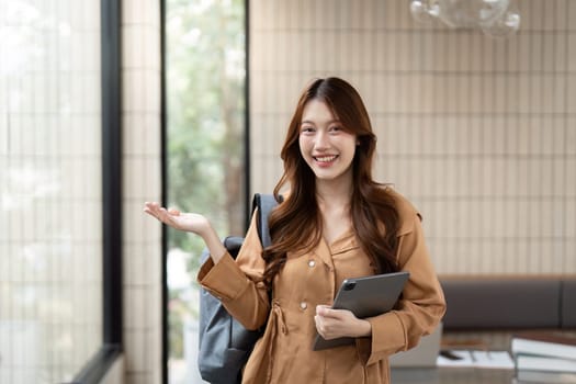 With a bright smile, a student proudly presents her journey, emphasizing confidence and the joy of learning in her university life.