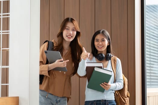 After a successful study session, two friends pose happily, showcasing their academic tools as symbols of achievement and teamwork.