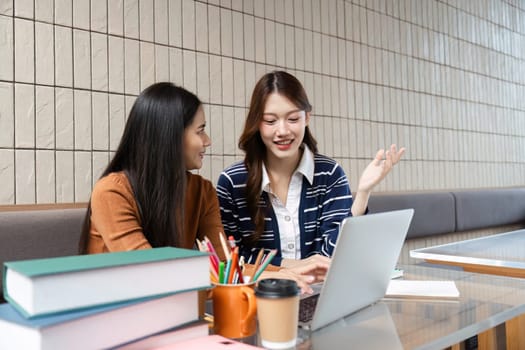 Two students work together on a project, sharing ideas and insights in a bright, modern study space. Their engagement emphasizes teamwork and academic support.
