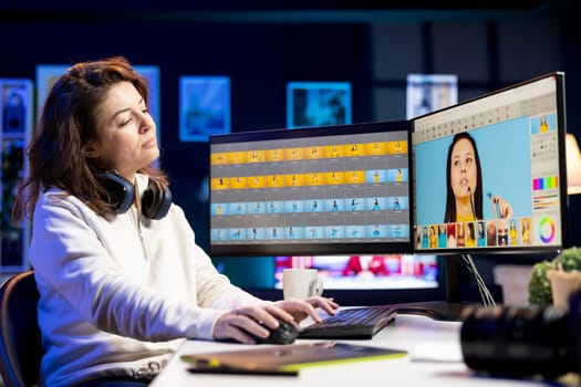 Content creator in digital multimedia company processing images with post production software. Photo editor selects best editorial photographs for advertising campaign and retouching on graphic tablet