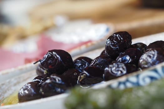 Platter features vibrant black olives ready for enjoyment and sharing