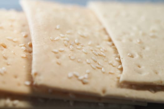 Different varieties of sesame crackers arranged neatly on a tray.