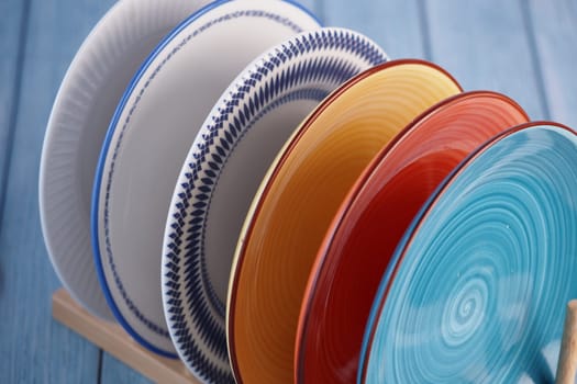 Brightly colored plates in various patterns are neatly arranged on display.