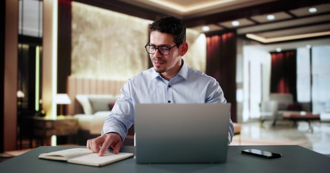Business Travel With Laptop In Hotel. Businessman In Luxury Room