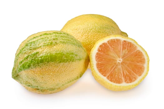 Two whole variegated pink lemons and one sliced in half isolated in white background. The lemons feature a textured skin and varied green and yellow hues. Bright and fresh.