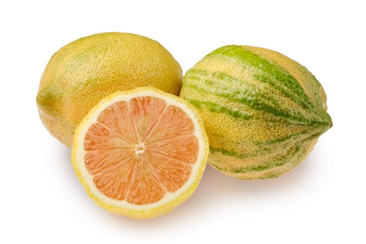 Two striped variegated pink lemons on a clean surface, one whole and one cut in half, revealing its juicy, pale orange flesh. The lemons highlight their unique texture and vivid colors, suggesting freshness.