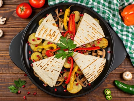 A vibrant mixed vegetable platter displays assorted grilled veggies such as bell peppers, mushrooms, and tomatoes, beautifully arranged with grilled tortillas and garnished with fresh herbs.