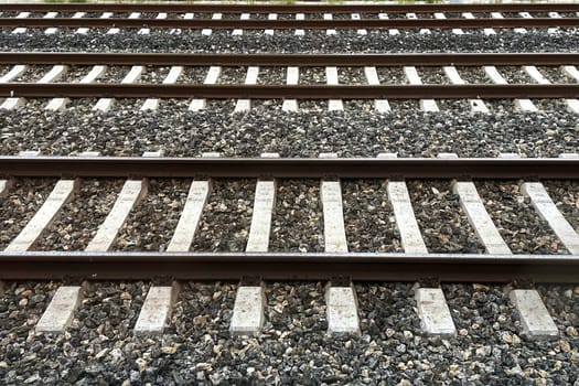 Railway Tracks Leading to the Horizon.A scenic view of multiple railway tracks stretching into the distance, emphasizing symmetry, structure, and the essence of travel. The image highlights precision engineering and evokes a sense of journey and connection.