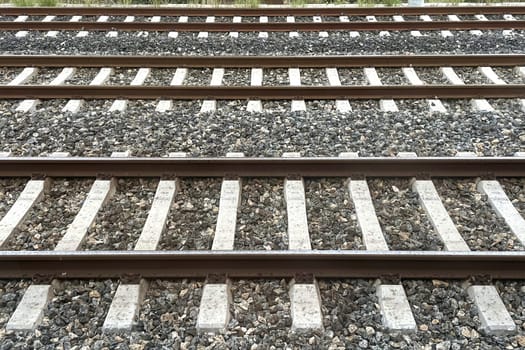 Railway Tracks Leading to the Horizon.A scenic view of multiple railway tracks stretching into the distance, emphasizing symmetry, structure, and the essence of travel. The image highlights precision engineering and evokes a sense of journey and connection.