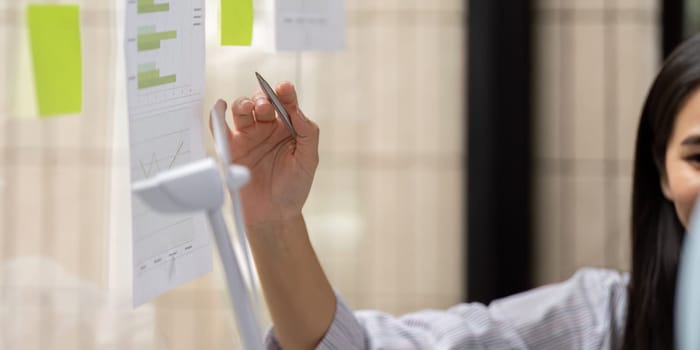 Focused on achieving sustainability goals, the woman engages her peers with clear insights into ESG metrics, driving meaningful conversations.