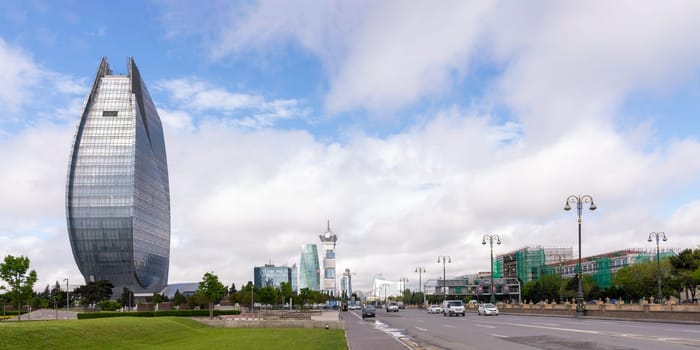 Baku, Azerbaijan - May 7, 2024: Heydar Aliyev Avenue, with its imposing Azersu Tower and contemporary architecture, provides a visually stunning experience with a harmonious blend of sleek designs