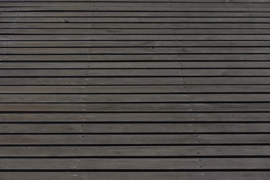 Sunlight gleams on the well-maintained wooden deck, showcasing its smooth lines and sturdy construction. This inviting outdoor space offers a perfect retreat.