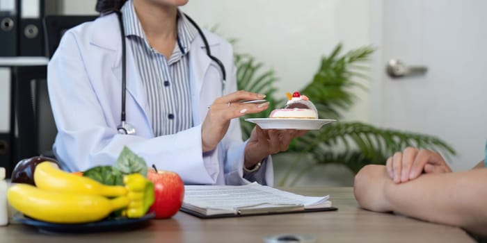 In a health consultation, the doctor emphasizes healthy eating by presenting a balanced dessert choice to the patient.