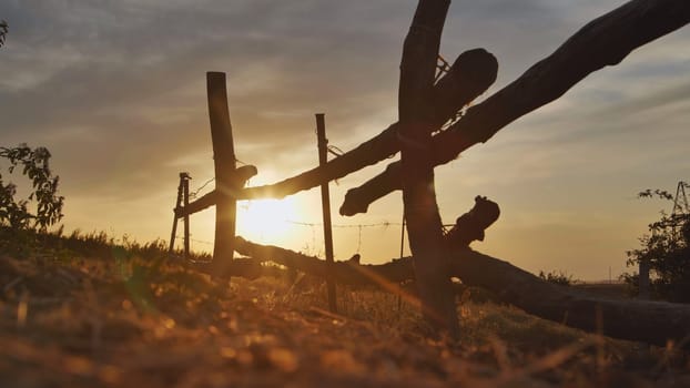 Beautiful sunset behind a wooden fence in the Crimean countryside near the town of Belogorsk