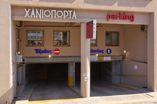 Crete.Greece - april 11, 2025: Entrance to an urban parking garage in Heraklion with clear Greek and English signage, guiding vehicles through designated lanes. The facility offers structured parking for city residents and visitors.