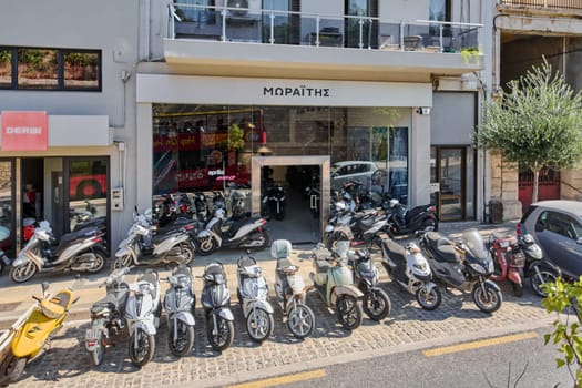 Crete.Greece - april 11, 2025: A motorcycle dealership in Crete featuring Greek signage, with multiple bikes displayed outside. The urban setting and storefront reflect local business activity and transportation culture.