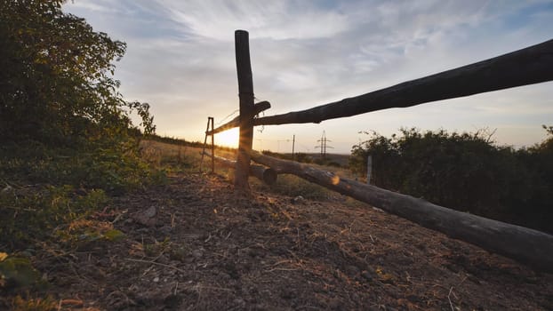 Sun setting behind wooden fence in Crimea near Belogorsk