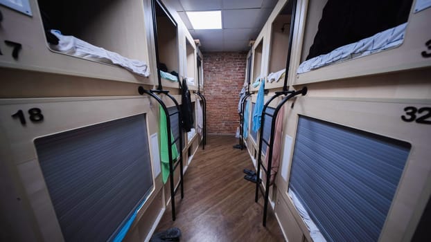 Interior of contemporary capsule hotel with compact sleeping pods providing budget-friendly lodging
